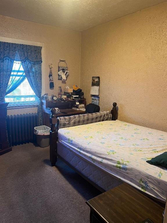 1619 Brownsville Road Pittsburgh, PA 15210 - Photo 20 of 33 a bed sitting in a bedroom next to a window