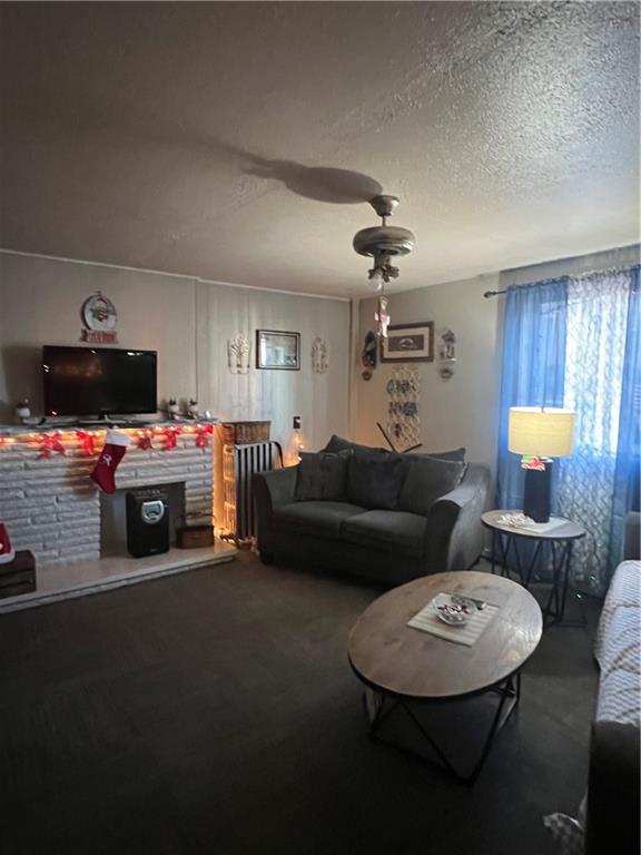 1619 Brownsville Road Pittsburgh, PA 15210 - Photo 7 of 33 a living room with furniture a fireplace and a chandelier