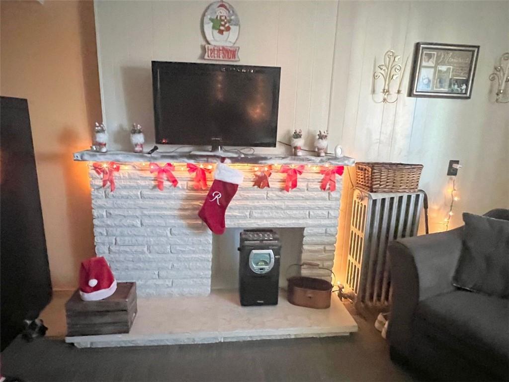 1619 Brownsville Road Pittsburgh, PA 15210 - Photo 8 of 33 a living room with furniture and a flat screen tv