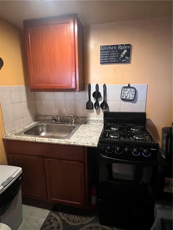 1619 Brownsville Road Pittsburgh, PA 15210 - Photo 10 of 33 a kitchen with a stove and a sink
