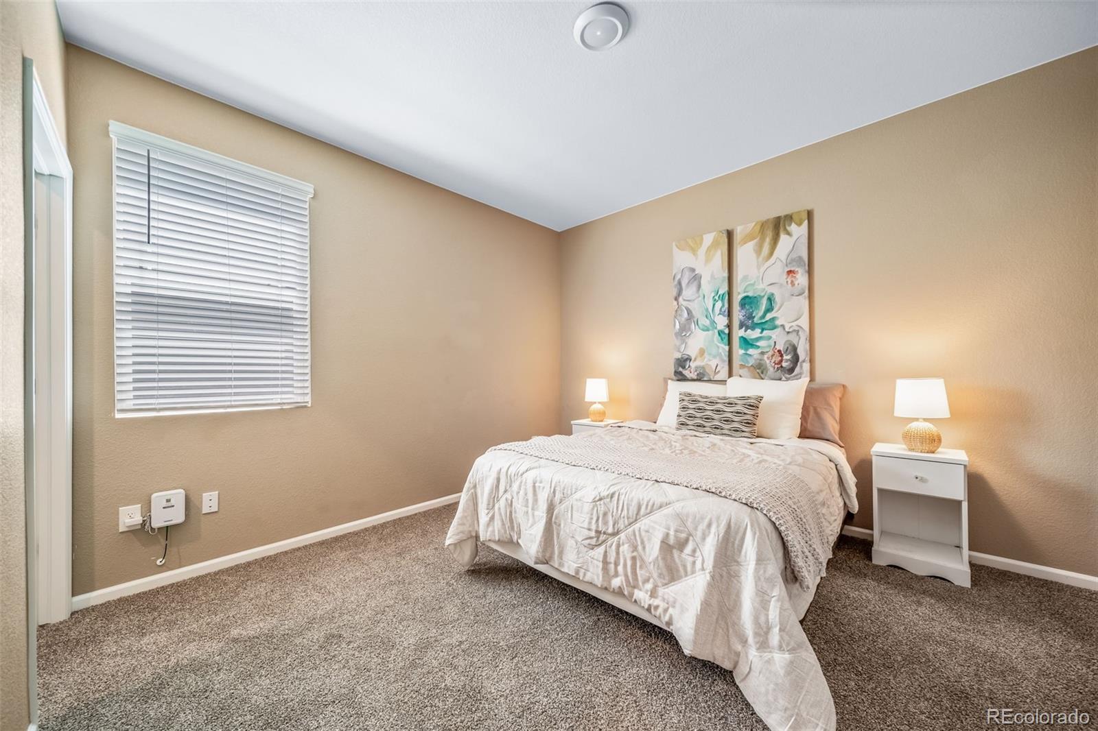 1 South Quantock Street Aurora, CO 80018 - Photo 19 of 43 a bedroom with a bed and a window