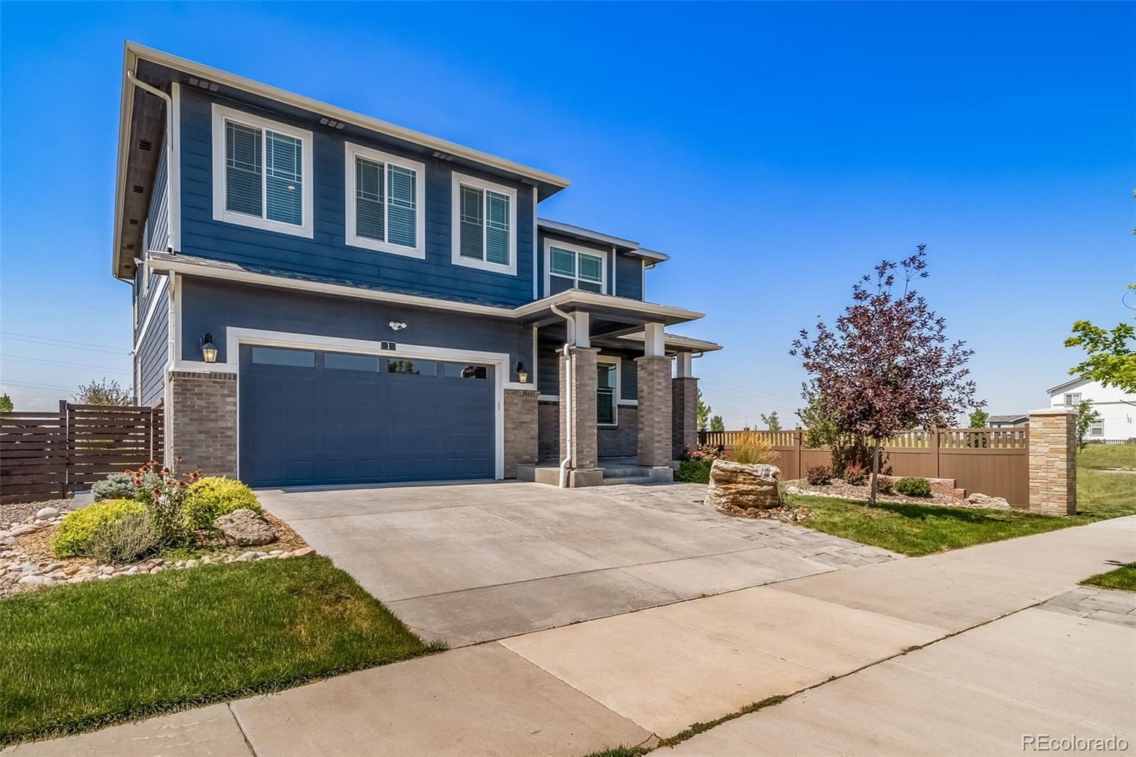1 South Quantock Street Aurora, CO 80018 - Photo 2 of 43 a front view of a house with a yard and garage