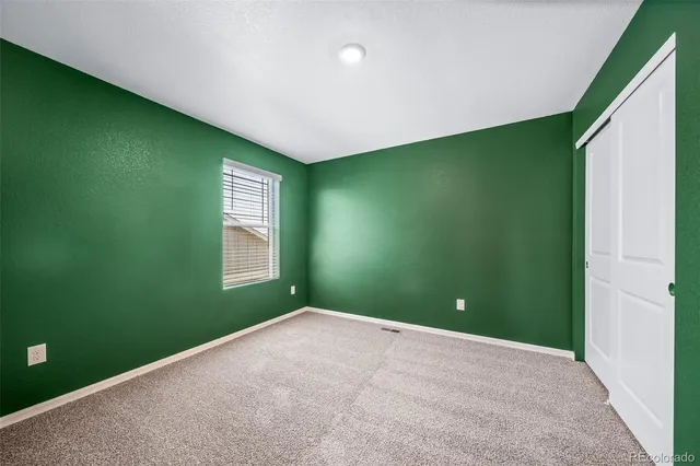 a view of a big room with windows and entryway