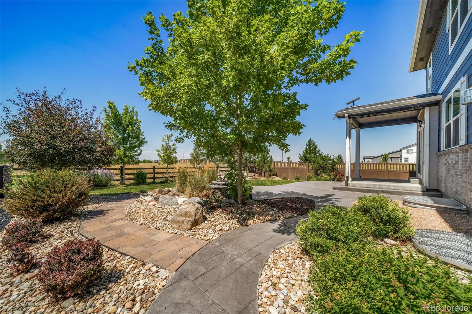 1 South Quantock Street Aurora, CO 80018 - Photo 33 of 43 a backyard of a house with a garden and outdoor seating