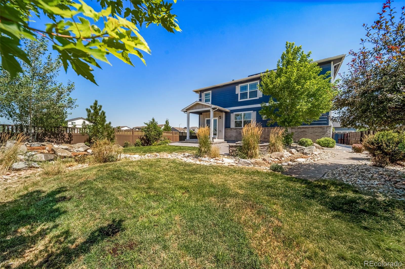 1 South Quantock Street Aurora, CO 80018 - Photo 34 of 43 a front view of a house with a yard