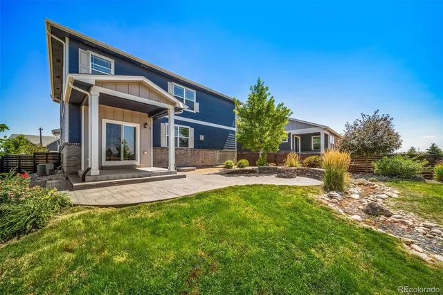 a front view of a house with sitting area and garden
