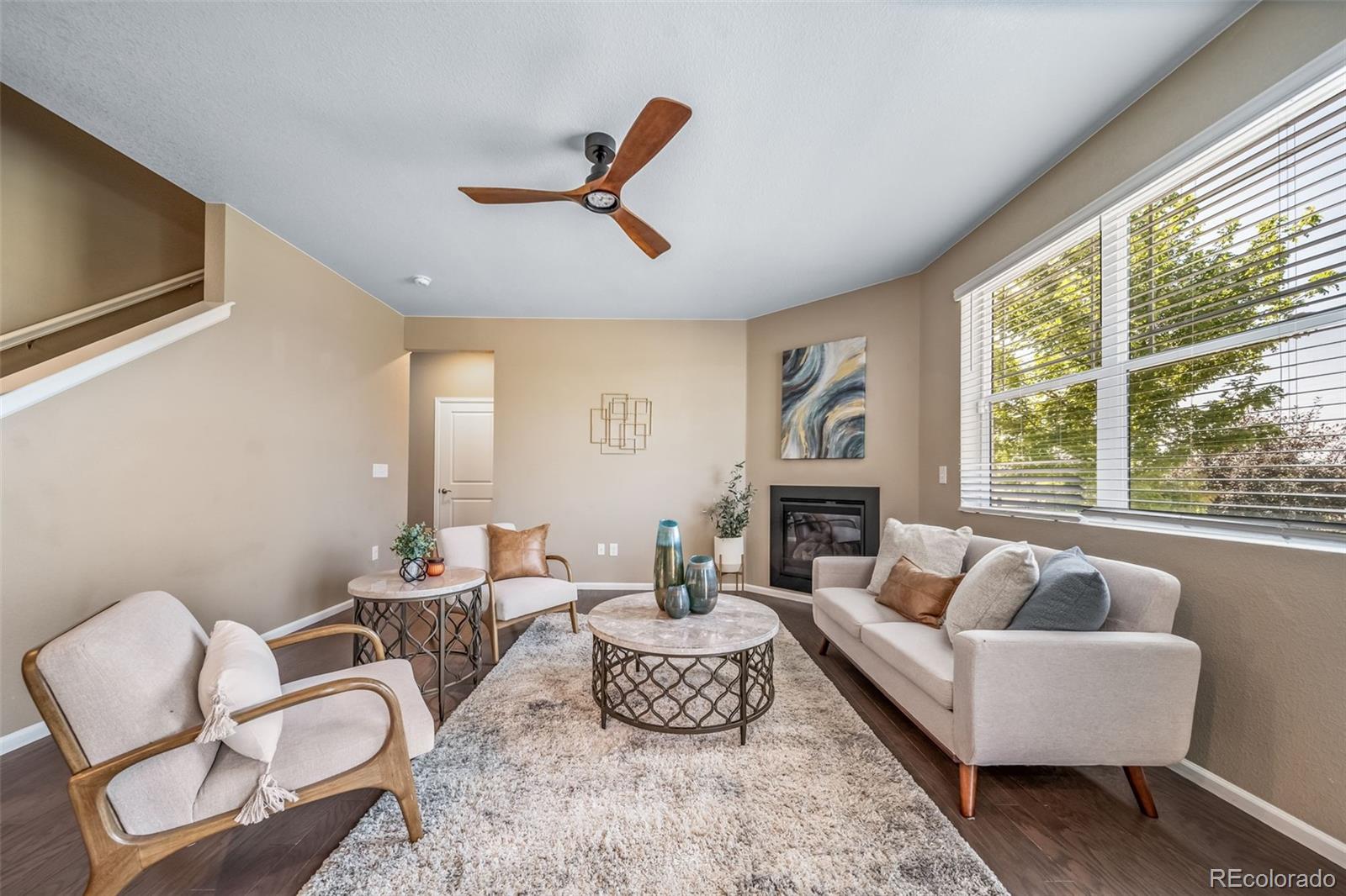 1 South Quantock Street Aurora, CO 80018 - Photo 5 of 43 a living room with furniture and a large window