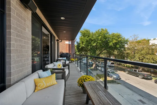 a view of roof deck with couches and wooden floor