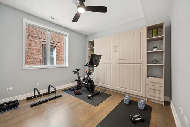 a room with gym equipment and a large window
