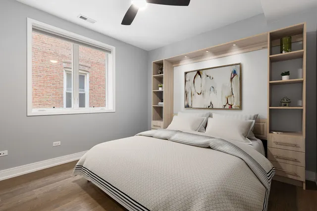 a bedroom with a bed and a painting on the wall