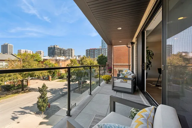 a balcony with furniture and a potted plant