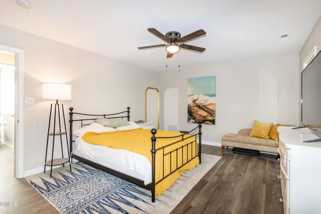 a bed room with a bed and a chandelier