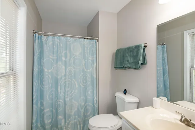 a white toilet sitting next to a bathroom sink