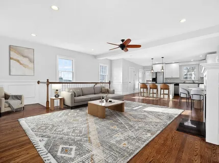 a living room with furniture and kitchen view