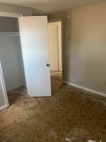 an empty room with wooden floor