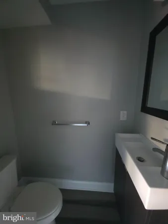 a bathroom with a sink a toilet and vanity