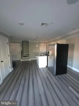 a view of kitchen with cabinets and wooden floor