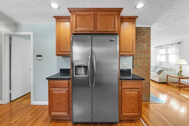 a kitchen with stainless steel appliances granite countertop a refrigerator and a sink