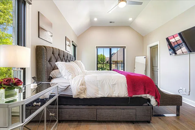 a bed room with a bed and a potted plant