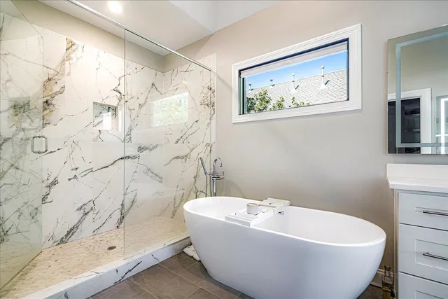 a white bath tub sitting next to a shower