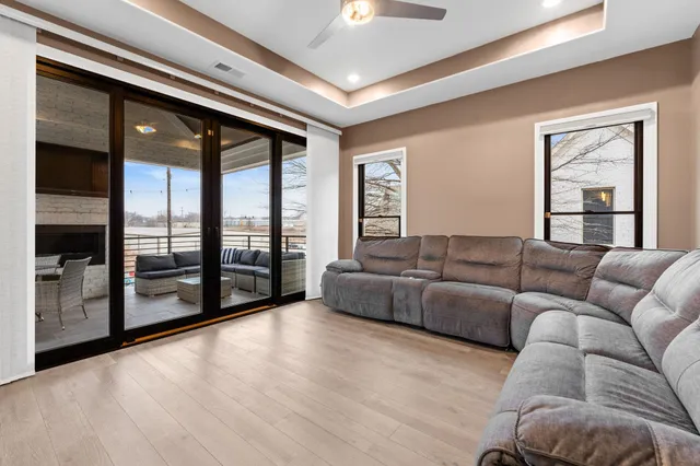 a living room with furniture and a floor to ceiling window
