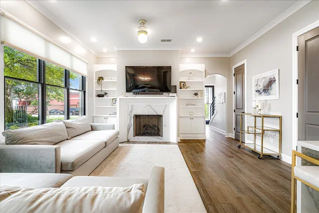 a living room with furniture a flat screen tv and a fireplace