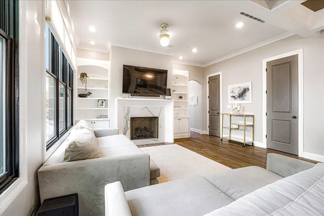 a living room with furniture a flat screen tv and a fireplace