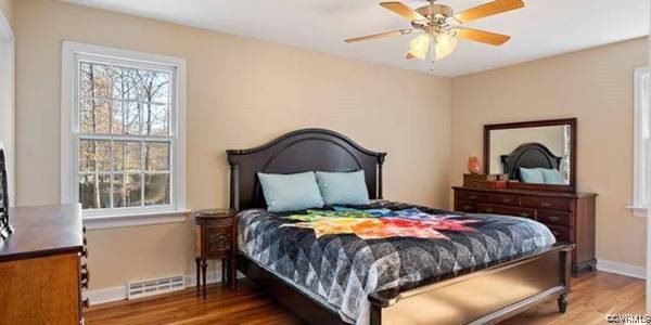 517 Wallingham Drive Midlothian, VA 23114 - Photo 9 of 11 a bedroom with a bed and a painting on the wall