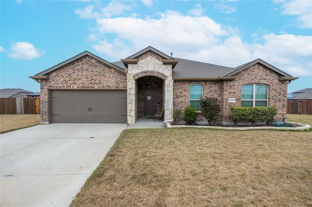 4009 Forest Bend Road Denton, TX 76208 - Photo 1 of 35 French country inspired facade featuring brick siding, an attached garage, concrete driveway, stone siding, and a shingled roof