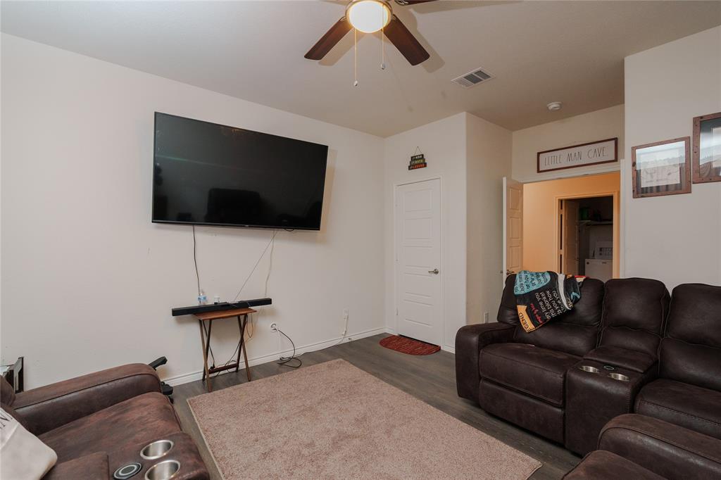 4009 Forest Bend Road Denton, TX 76208 - Photo 16 of 35 Living room with dark wood-style floors and ceiling fan
