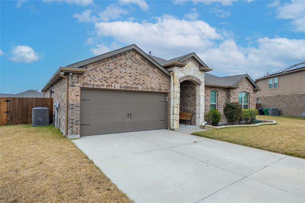 4009 Forest Bend Road Denton, TX 76208 - Photo 2 of 35 French country inspired facade featuring brick siding, an attached garage, and a front yard