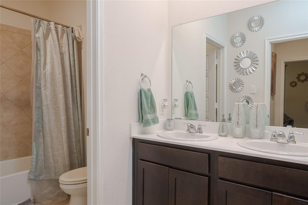 4009 Forest Bend Road Denton, TX 76208 - Photo 23 of 35 Bathroom with double vanity and shower / bath combination with curtain
