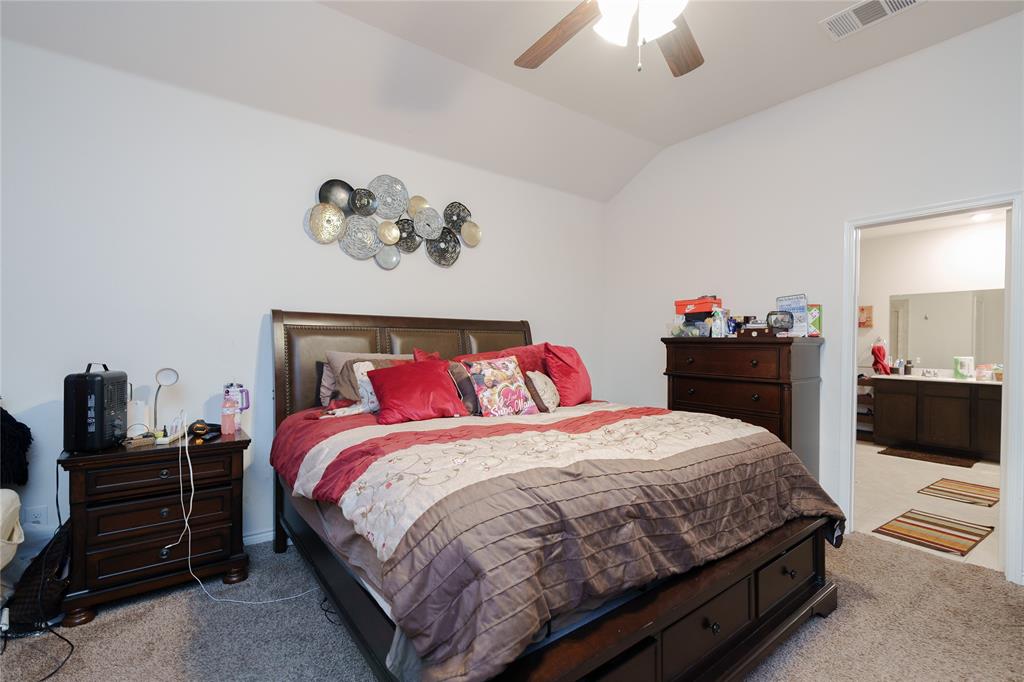 4009 Forest Bend Road Denton, TX 76208 - Photo 25 of 35 Carpeted bedroom with lofted ceiling, ceiling fan, and ensuite bathroom