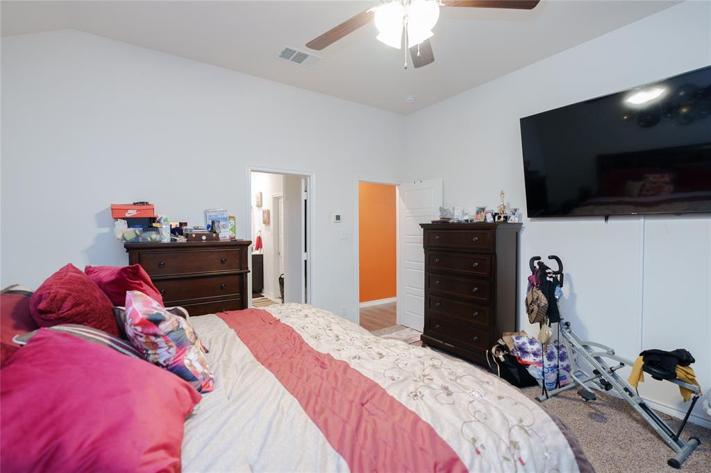 4009 Forest Bend Road Denton, TX 76208 - Photo 26 of 35 Bedroom featuring a ceiling fan, lofted ceiling, and connected bathroom