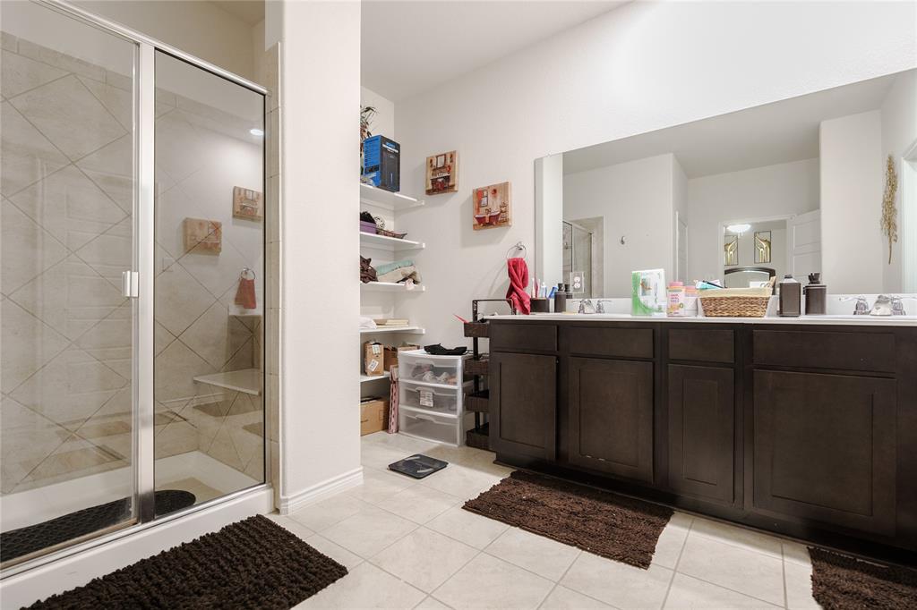4009 Forest Bend Road Denton, TX 76208 - Photo 28 of 35 Bathroom with double vanity, a shower stall, and light tile patterned floors