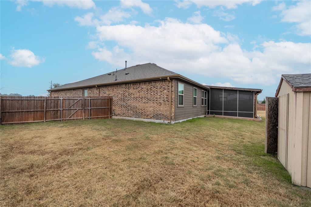 4009 Forest Bend Road Denton, TX 76208 - Photo 34 of 35 Back of house featuring a fenced backyard, a sunroom, and brick siding