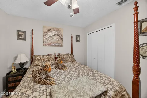 a bedroom with a large bed and a chandelier