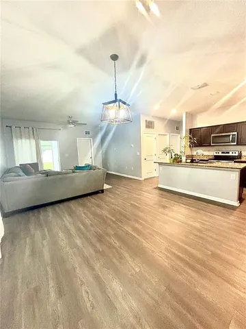 a view of a kitchen with a sink stainless steel appliances and cabinets