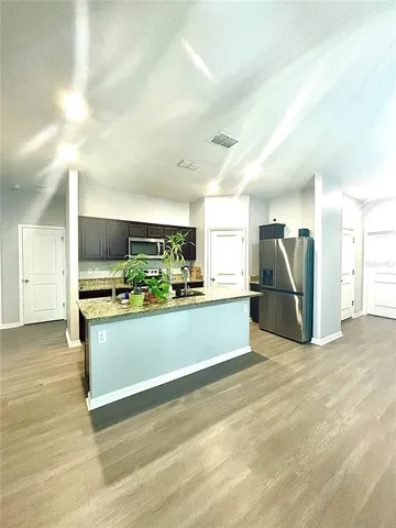 a spacious bedroom with a bed and a chandelier