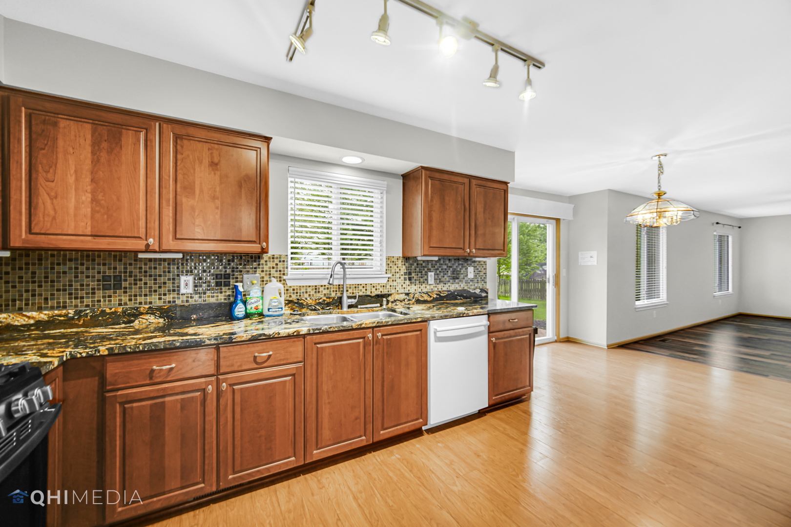 21432 Georgetown Drive Plainfield, IL 60544 - Photo 6 of 24 a kitchen with stainless steel appliances granite countertop wooden cabinets a sink and dishwasher with wooden floor
