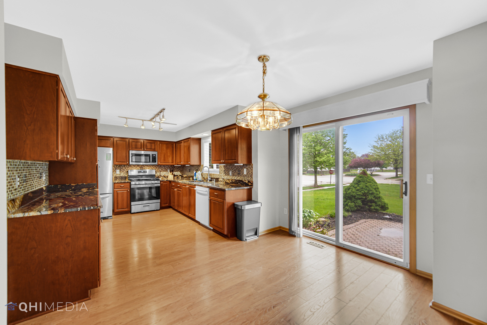 21432 Georgetown Drive Plainfield, IL 60544 - Photo 7 of 24 a view of a kitchen with granite countertop stainless steel appliances and a chandelier