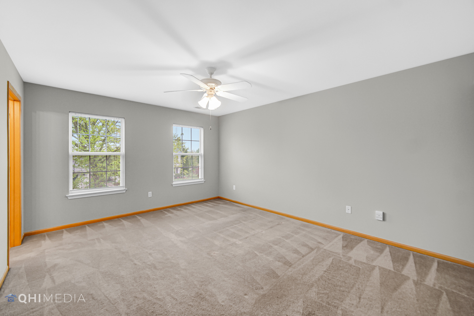 21432 Georgetown Drive Plainfield, IL 60544 - Photo 9 of 24 an empty room with windows and ceiling fan