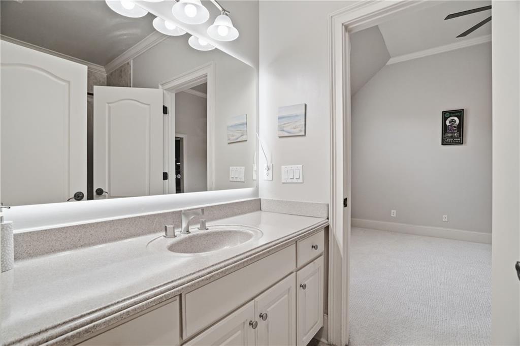 8340 Colonial Place Duluth, GA 30097 - Photo 41 of 74 a bathroom with a sink a vanity and a mirror
