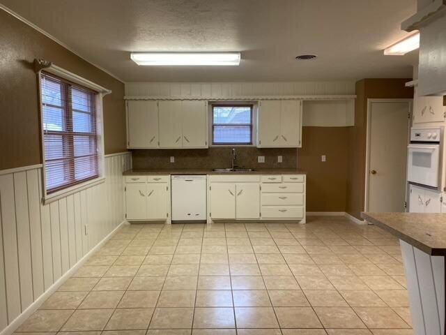 3011 55th Street Lubbock, TX 79413 - Photo 11 of 25 a kitchen with a cabinets and a stove top oven