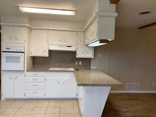 3011 55th Street Lubbock, TX 79413 - Photo 12 of 25 a kitchen with granite countertop a sink and a stove with white countertops