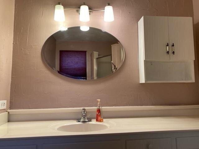 3011 55th Street Lubbock, TX 79413 - Photo 17 of 25 a bathroom with a sink and a mirror
