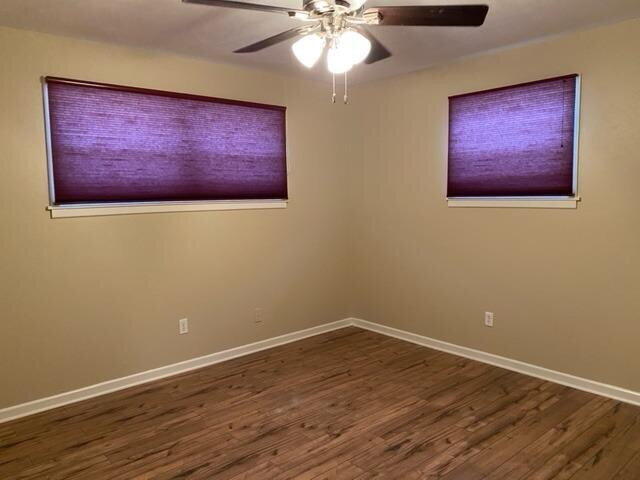 3011 55th Street Lubbock, TX 79413 - Photo 24 of 25 a view of an empty room with wooden floor and a ceiling fan