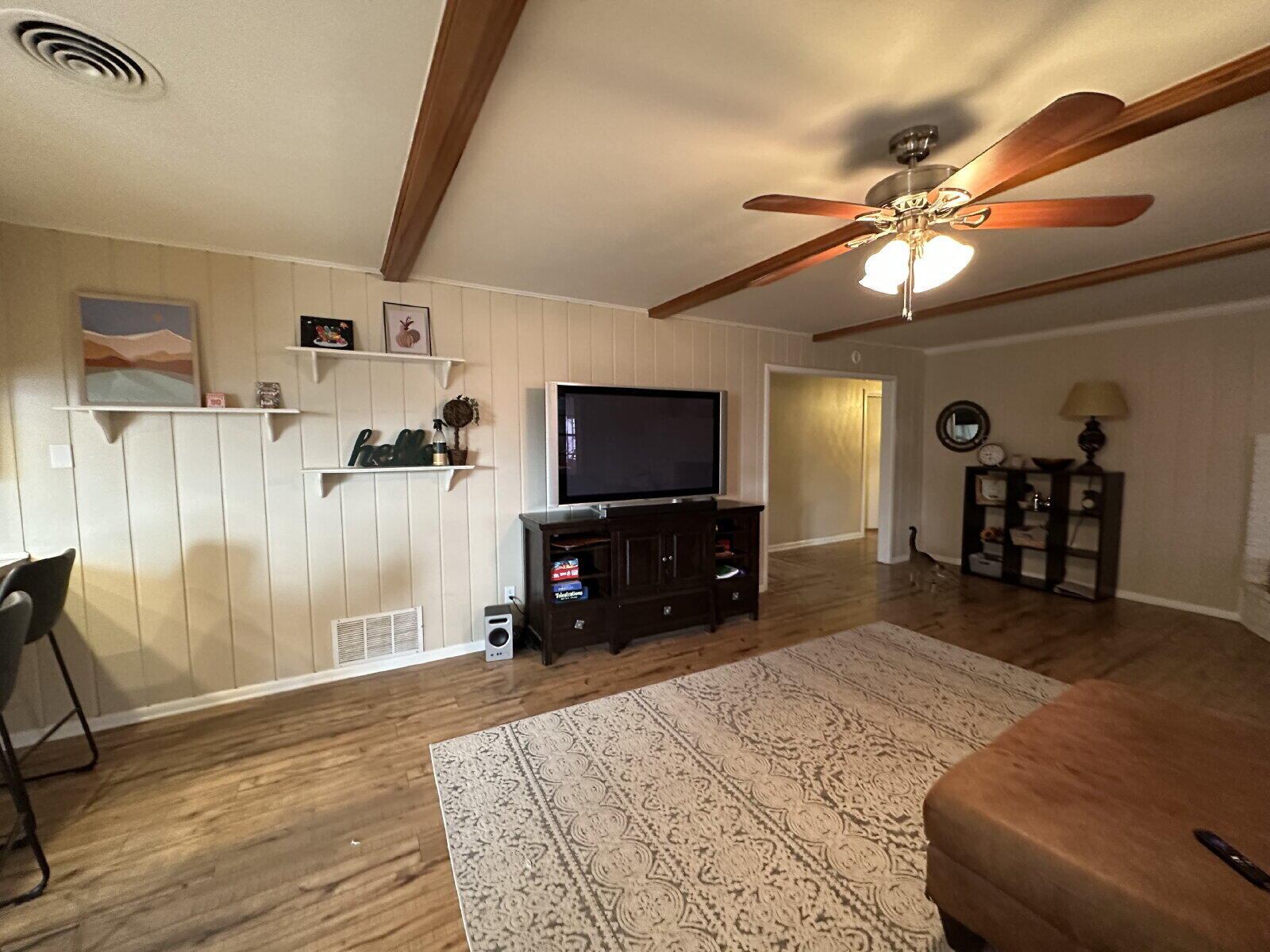 3011 55th Street Lubbock, TX 79413 - Photo 3 of 25 a bedroom with furniture and a flat screen tv