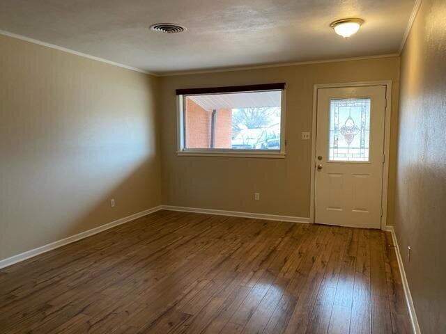 3011 55th Street Lubbock, TX 79413 - Photo 7 of 25 an empty room with wooden floor and windows