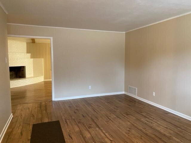 3011 55th Street Lubbock, TX 79413 - Photo 8 of 25 an empty room with wooden floor and windows